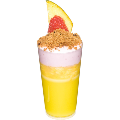 Image of Yellow dessert in a glass with a raspberry and pineapple slice on a white background